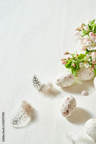 Holiday composition with spring flowers and easter eggs on a light background. Happy easter concept with copy space
