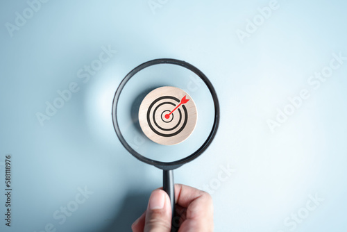 Magnifier glass focus to target icon which for planning development leadership and customer target group concept.