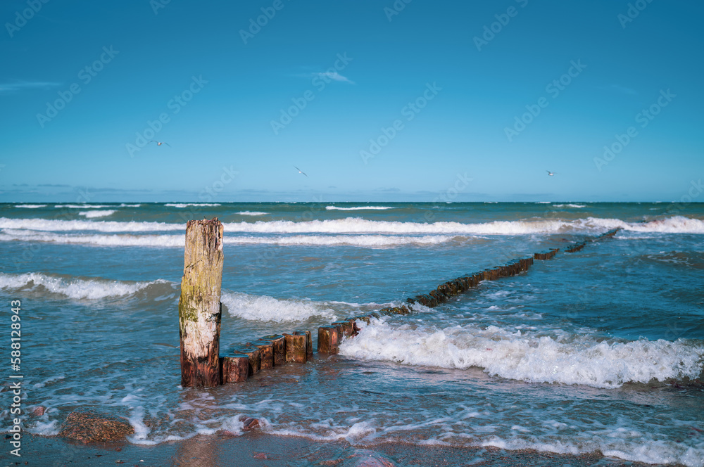 the groynes in the Baltic Sea are washed over by waves.