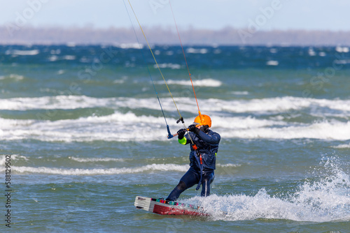 one kitesurfer surfing in stormy weather on the baltic sea © karegg