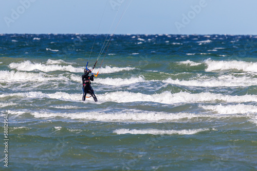 one kitesurfer surfing in stormy weather on the baltic sea