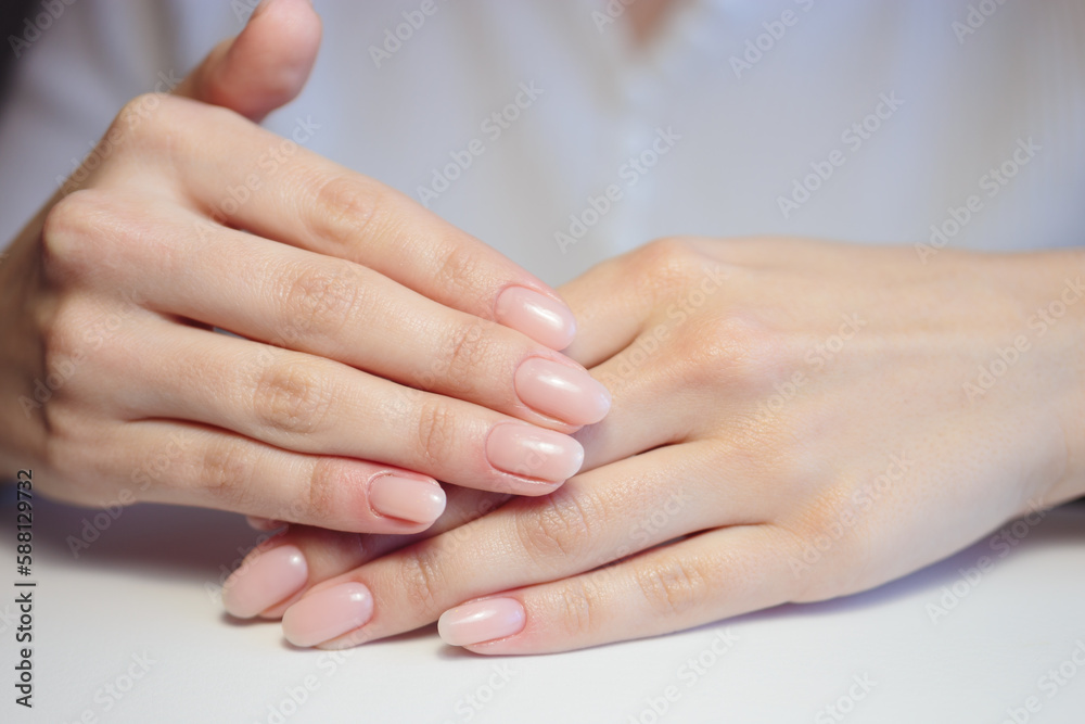 Gentle nude manicure on her nails. Classic bridal nail design. Gentle nude manicure on her nails. Classic bridal nail design.