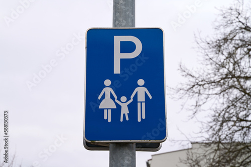 Traffic sign with the information that the parking lot is only allowed for families with children. Blue sign with mother, father and child. Family friendly parking.