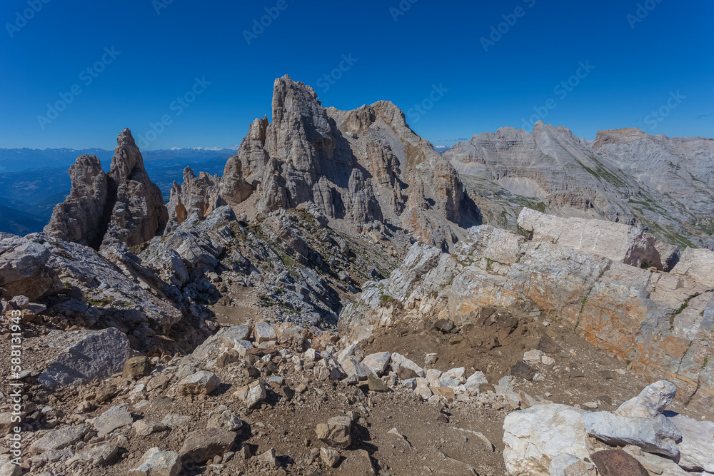 Awesome summer dolomite rocky scenario with giant pinnacles and ridges in the Latemar Massif, UNESCO world heritage site. The main pinnacle is named Torre di Pisa. Trentino-Alto Adige, Italy, Europe