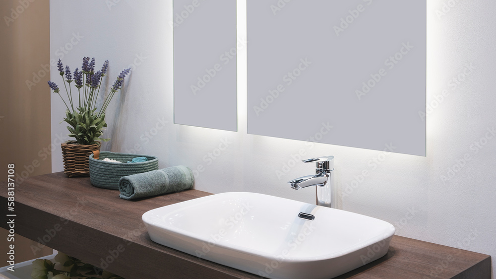Fototapeta premium White washbasin with faucet on wooden countertop in minimalist modern bathroom, scandinavian interior with stylish gray wall and round mirror. Copy space and nobody.
