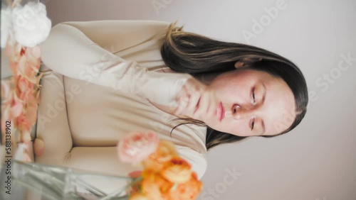 Wallpaper Mural Female model posing with flowers. Close-up portrait 4K video. The young and attractive dark hair actor with dark eyes. Skincare concept video for social media.  Torontodigital.ca