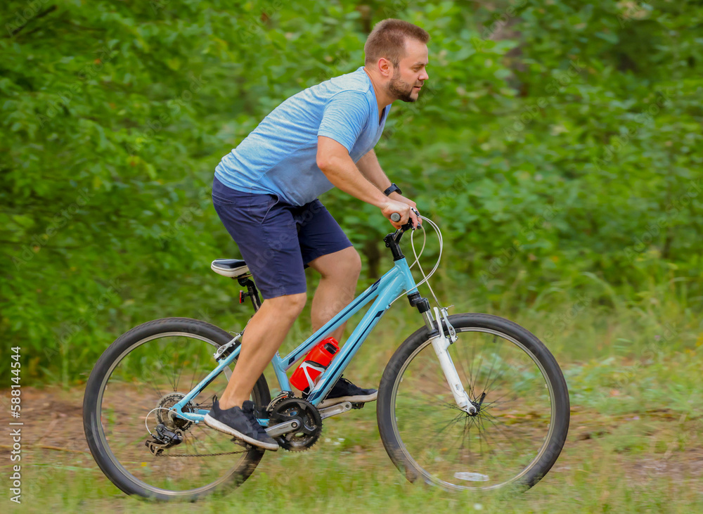 man riding a bike in the forest man riding a bike in the forest