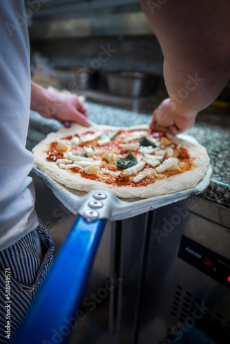 Pizza Napoletana Italian Pizza in the making by cook 