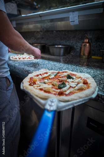 Pizza Napoletana Italian Pizza in the making by cook 