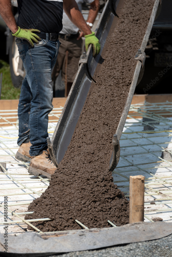 Workers pouring concrete for a stamped floor