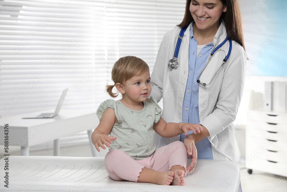 Pediatrician examining cute little baby in clinic Pediatrician examining cute little baby in clinic