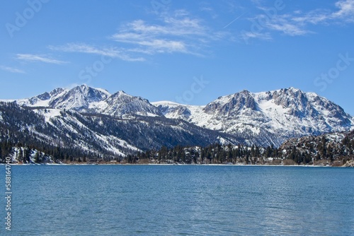 Snow tops the Sierra Nevada Mountains from the crystal clear waters of June Lake, which sits at the bottom of the mountain range's steep eastern escarpment © Andrew Webb Curtis
