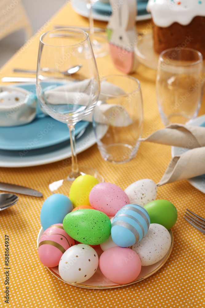 Festive table setting with painted eggs, glasses and cutlery. Easter celebration Festive table setting with painted eggs, glasses and cutlery. Easter celebration