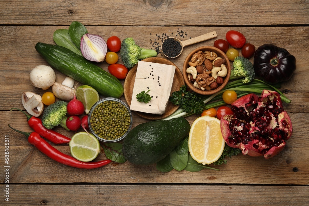 Different vegetables on wooden table, flat lay. Vegan diet Different vegetables on wooden table, flat lay. Vegan diet