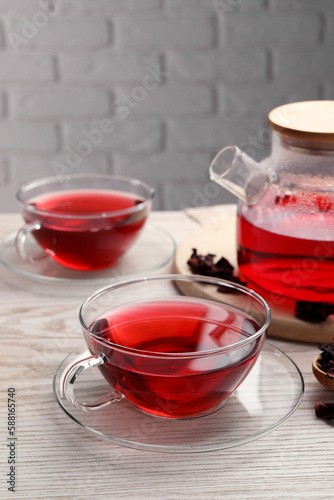 Tasty fresh hibiscus tea on wooden table