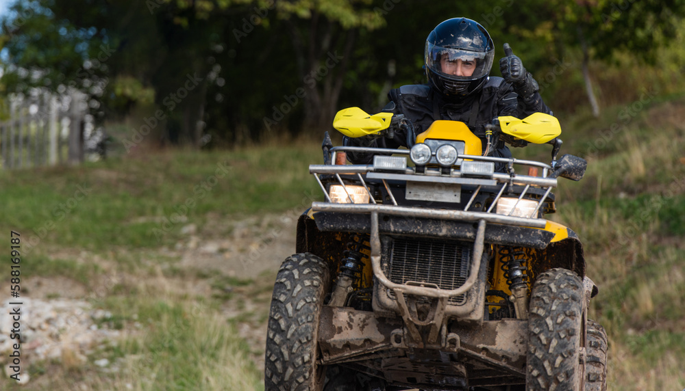 Adventurous driving of ATV motorbikes. A man drives a quad bike on dangerous roads Adventurous driving of ATV motorbikes. A man drives a quad bike on dangerous roads
