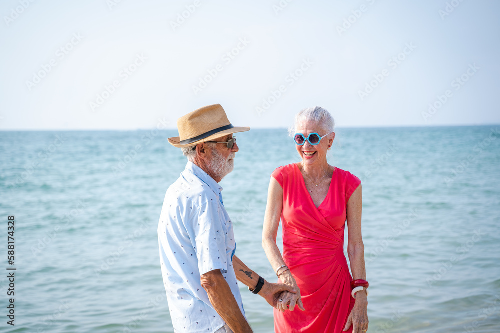 Happy senior couple walking together on beach on beautiful day,Authentic Senior Retired Life Concept Happy senior couple walking together on beach on beautiful day,Authentic Senior Retired Life Concept