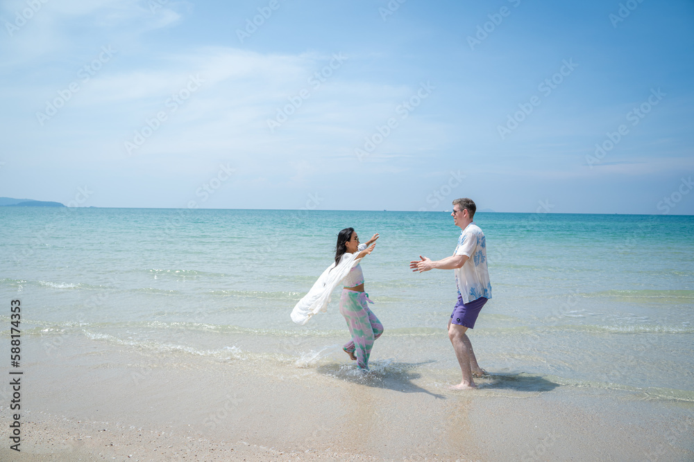 Happy young beautiful couple man and woman on the beach,Fun,Holiday. Happy young beautiful couple man and woman on the beach,Fun,Holiday.