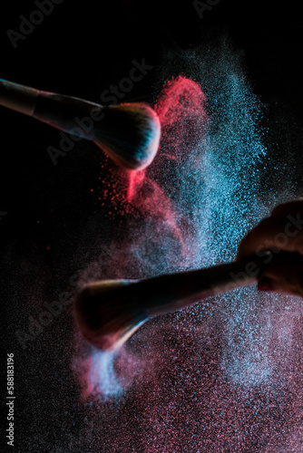 high speed action with powder in cosmetics photography, dancing powder, black background, selective focus. 