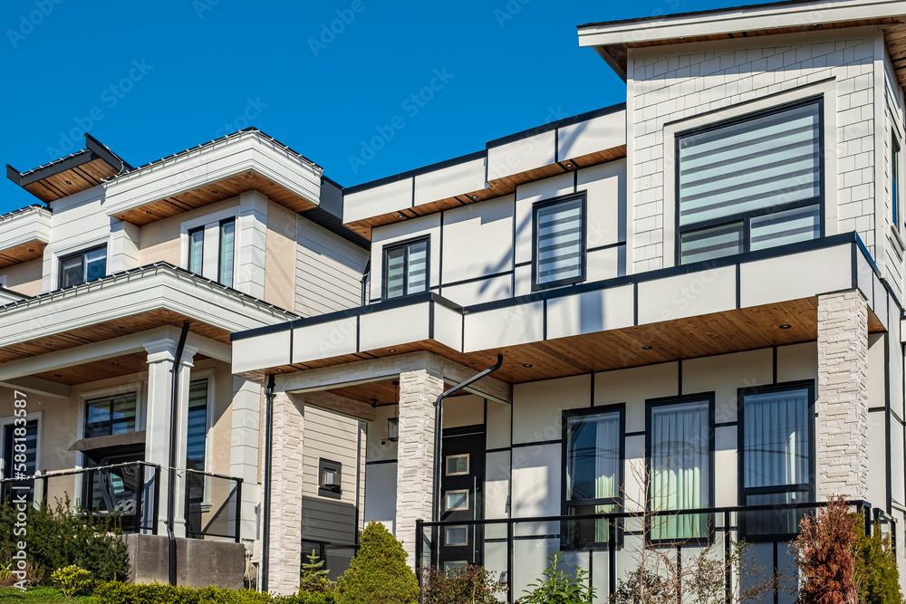 Real Estate Exterior Front House on a sunny day. Big custom made luxury house with nicely landscaped front yard