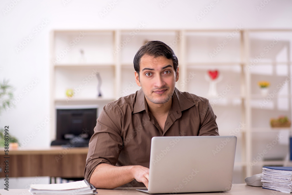 Young attractive employee sitting in the office Young attractive employee sitting in the office