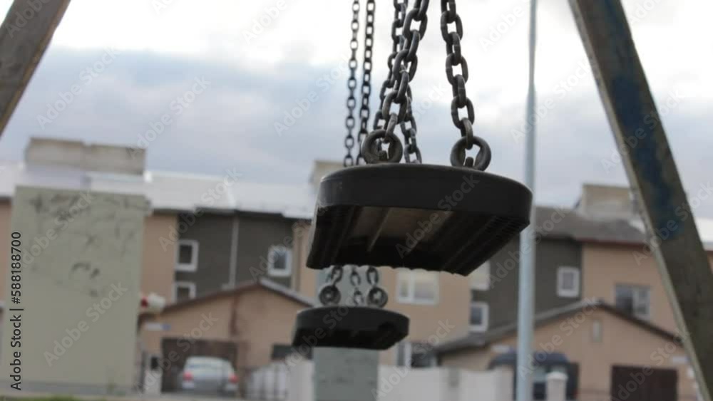Abandoned swing set on children playground in a city yard Abandoned swing set on children playground in a city yard