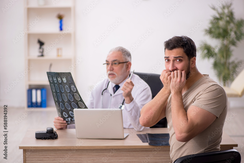 Young male patient visiting old male doctor radiologist