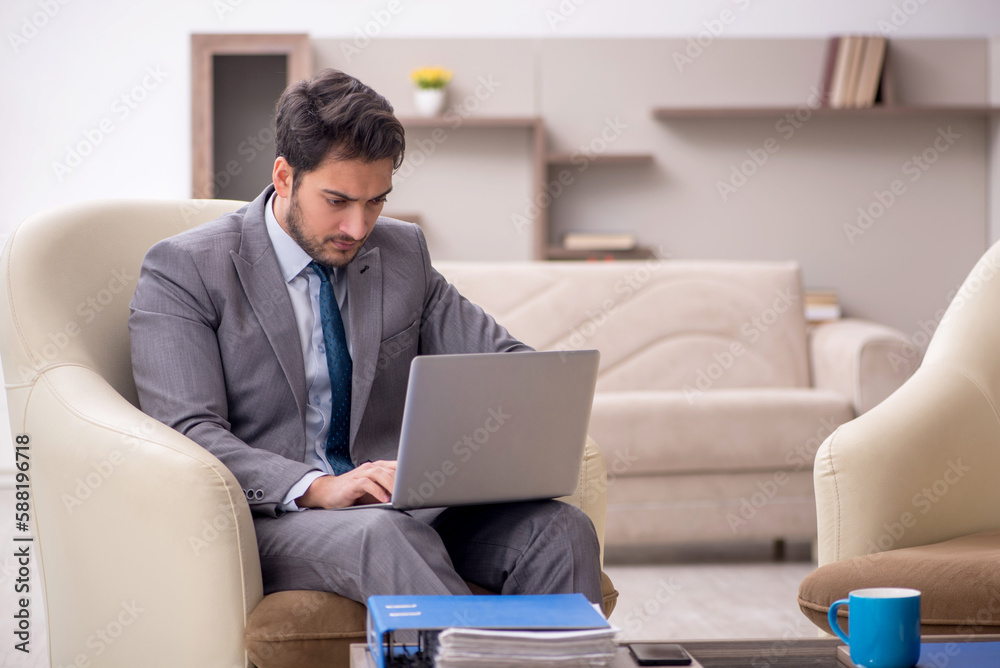 Young male employee working from home Young male employee working from home