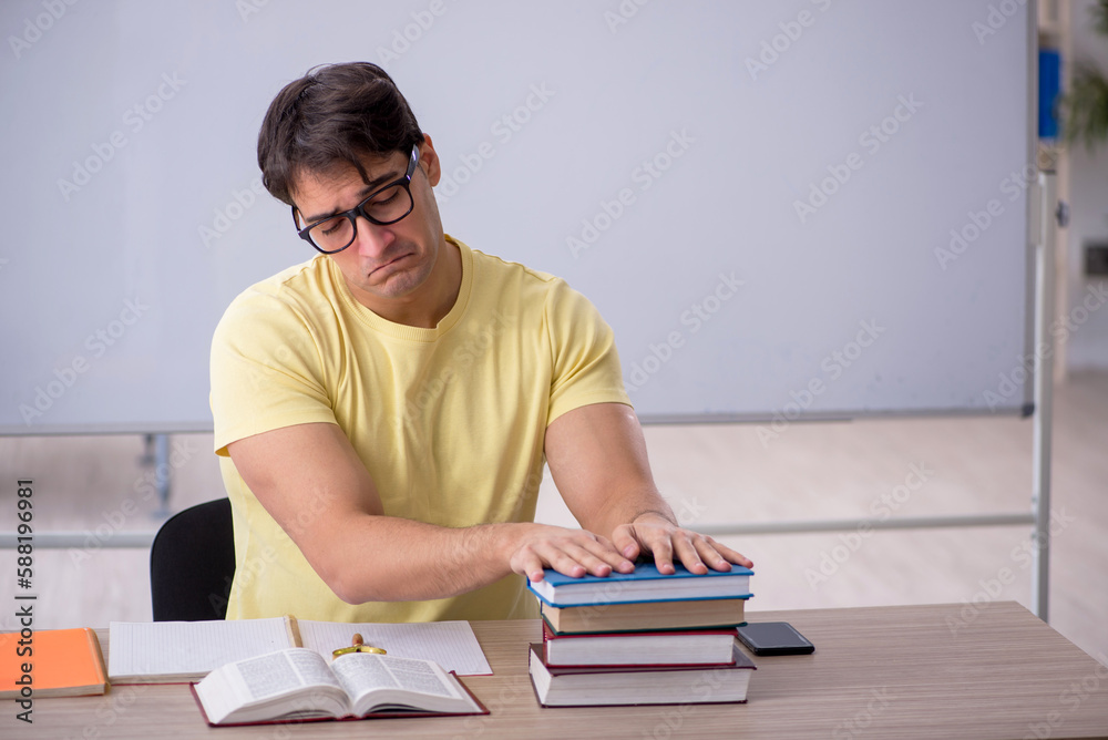 Young male student sitting in the classroom Young male student sitting in the classroom