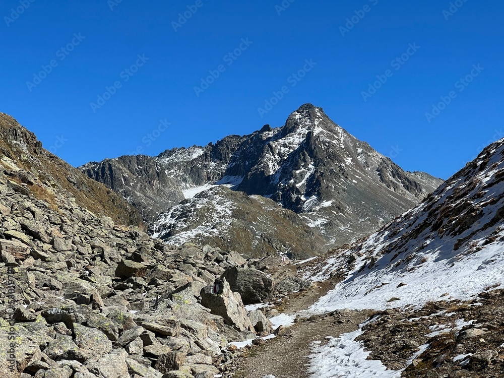 Hiking trails or mountaineering routes in the autumn Swiss Alpine environment of the Albula Alps and above the mountain road pass Fluela (Flüelapass), Zernez - Canton of Grisons, Switzerland (Schweiz)