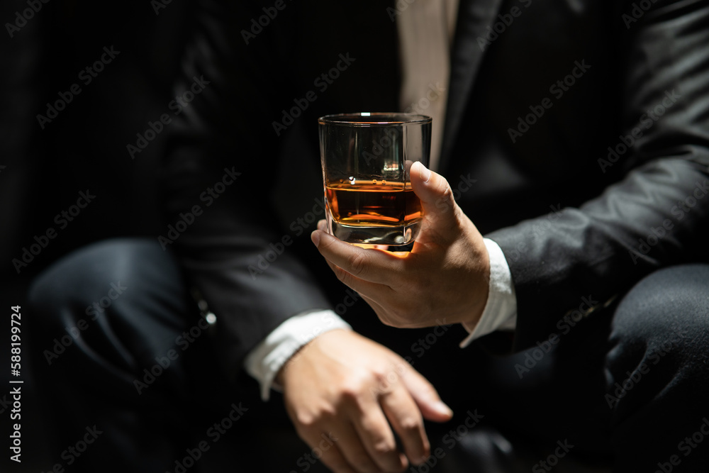 Businessman pouring whiskey victory drink