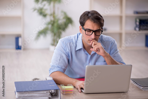 Young male employee working in the office