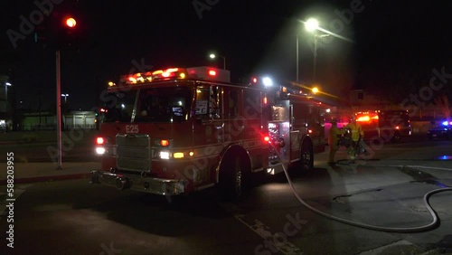 fire truck parked with flashing lights and sirens- establishing photo