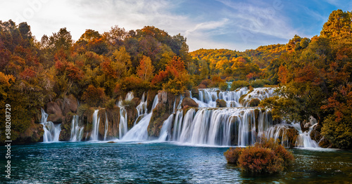 Krka  Croatia - Panoramic view of the famous Krka Waterfalls in Krka National Park on a bright autumn morning with amazing colorful autumn foliage and blue sky