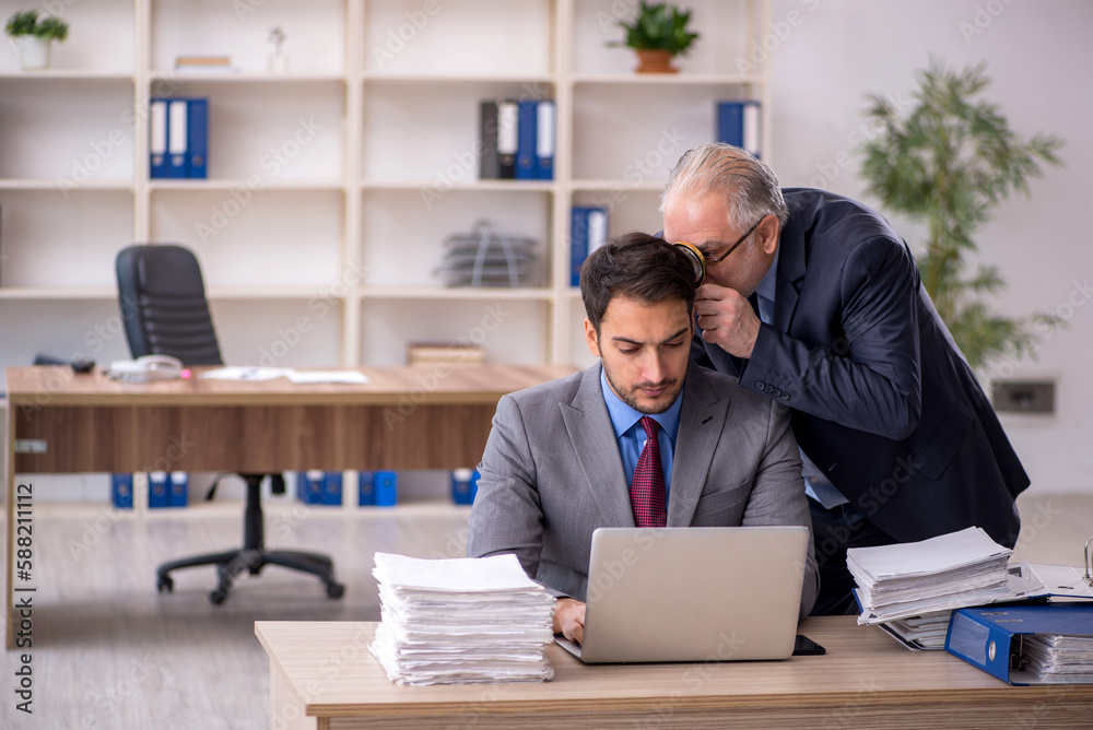 Two male colleagues working in the office Two male colleagues working in the office