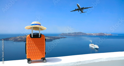 Fototapeta Naklejka Na Ścianę i Meble -  Banner of travel concept with Orange luggage and hat as landscape view of Oia town in Santorini island in Greece , Greek landscape as blue sky background