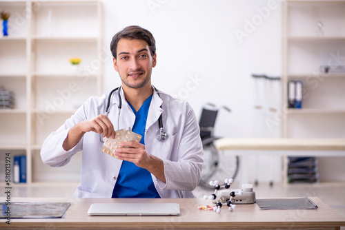 Young male doctor working in the clinic