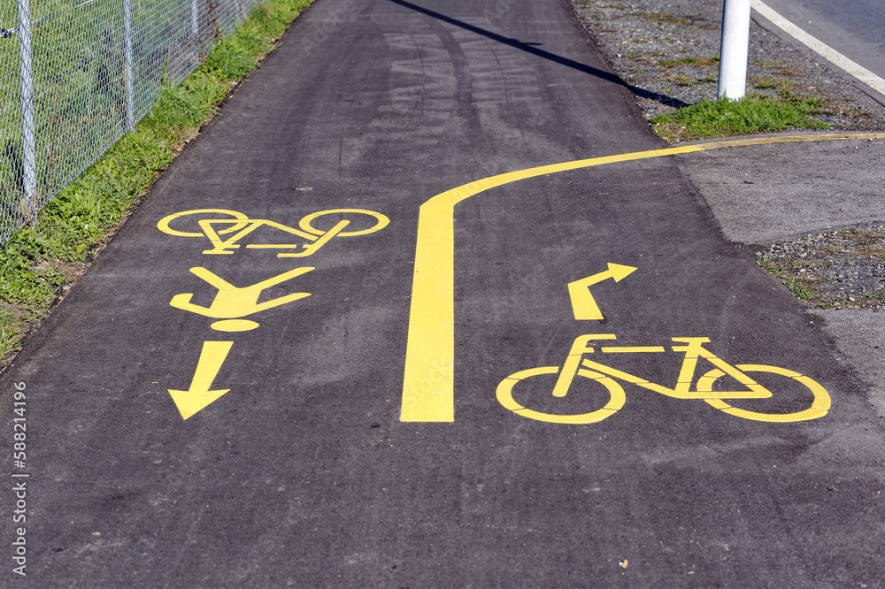 Obraz premium Yellow rad markings at combined footpath and bicycle lane at City of Emmen, Canton Luzern, on a sunny spring day. Photo taken March 22nd, 2023, Emmen, Switzerland.