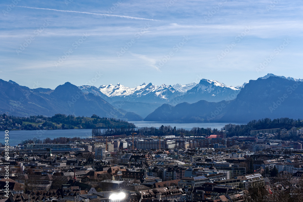 Aerial view of famous Swiss City of Luzern with Lake Luzern and the Swiss Alps in the background on a sunny spring day. Photo taken March 22nd, 2023, Lucerne, Switzerland.