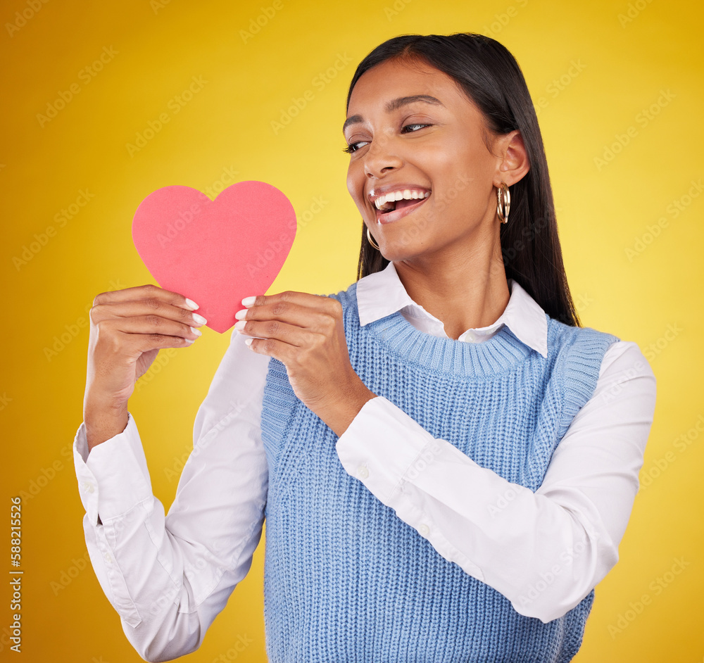 Happy, paper and heart with woman in studio for love, support and romance. Valentines day, kindness and date with female and holding symbol on yellow background for health, happiness and hope Happy, paper and heart with woman in studio for love, support and romance. Valentines day, kindness and date with female and holding symbol on yellow background for health, happiness and hope