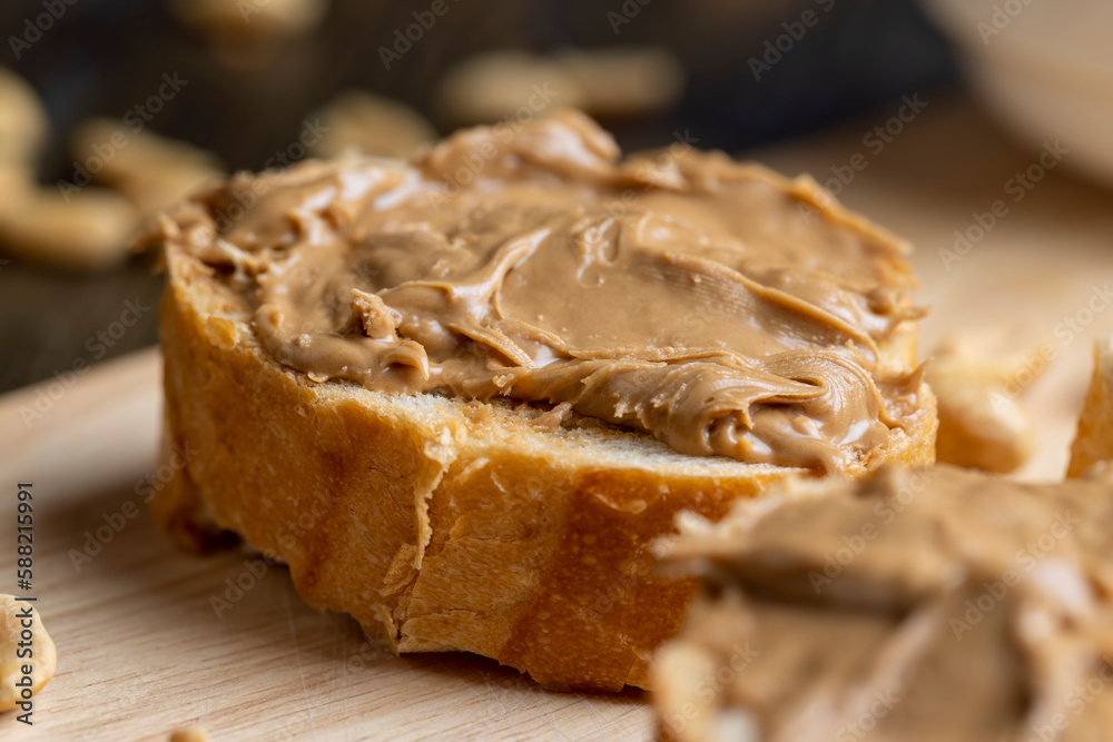 Peanut paste on a soft wheat baguette Peanut paste on a soft wheat baguette