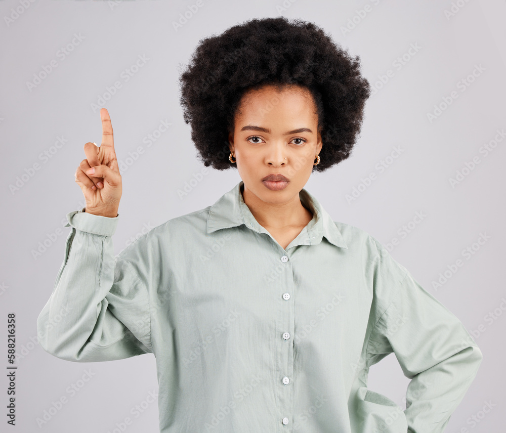 Mad, pointing and portrait of black woman in studio for product placement, promotion and announcement mockup. Idea, space and show with female on gray background for disappointed, annoyed or serious Mad, pointing and portrait of black woman in studio for product placement, promotion and announcement mockup. Idea, space and show with female on gray background for disappointed, annoyed or serious