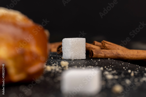Refined sugar pieces on a black slate board