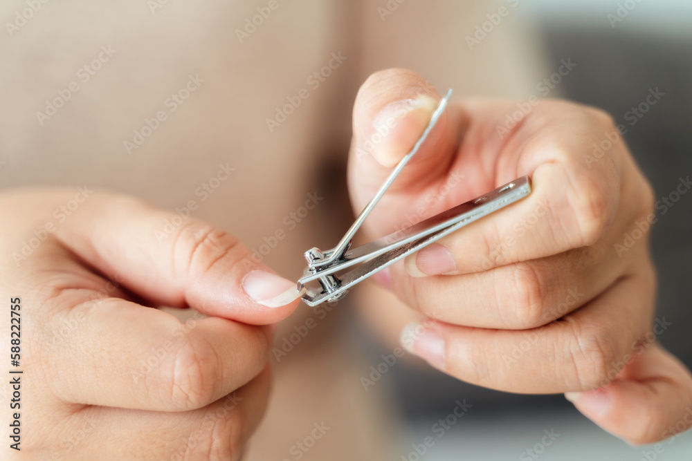 Woman cutting fingernails using nail clipper, Healthcare, Beauty Concept. Woman cutting fingernails using nail clipper, Healthcare, Beauty Concept.