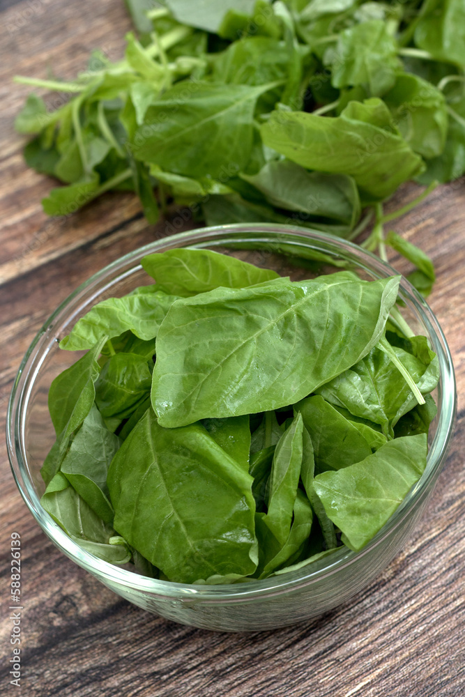 fresh raw spinach leaves in a glass bowl fresh raw spinach leaves in a glass bowl