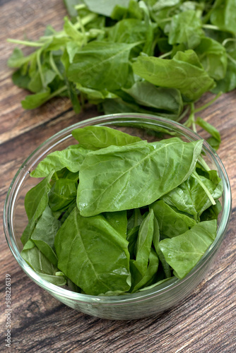 fresh raw spinach leaves in a glass bowl