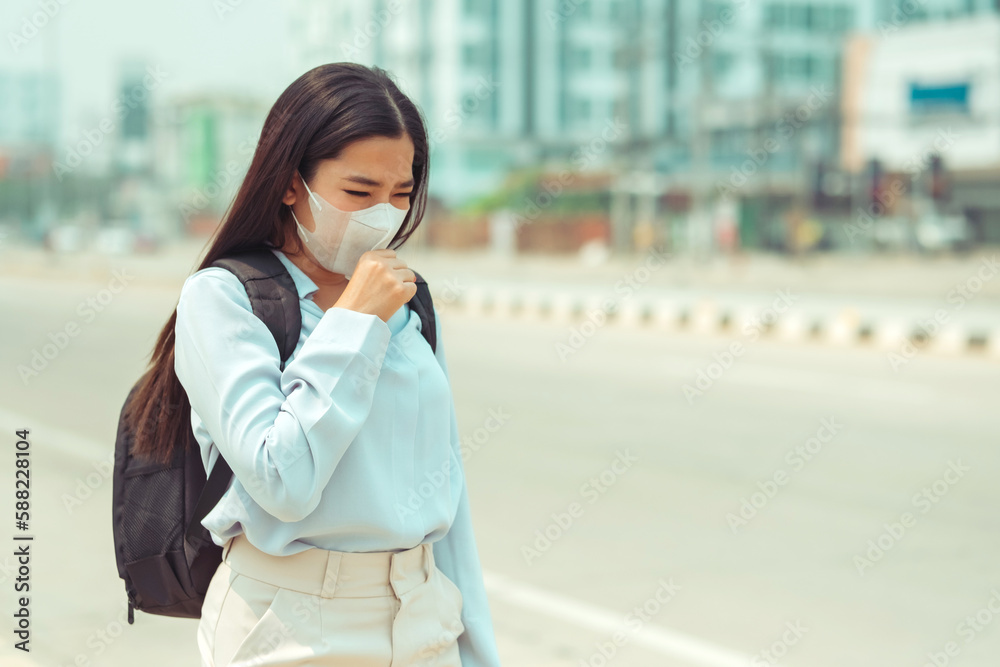 Asian Women wearing Protection Mask feels headaches and cough due to