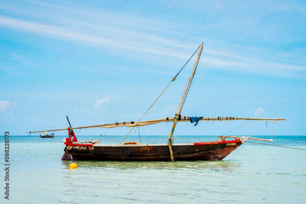 A wooden fishing boat with a traditional design, commonly found in Tanzania and located in the Indian Ocean near Zanzibar. A wooden fishing boat with a traditional design, commonly found in Tanzania and located in the Indian Ocean near Zanzibar.