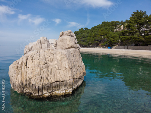 rock, beach, sea water and sand
