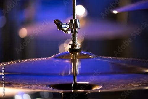 Drum cymbal close-up on a dark blurred background.